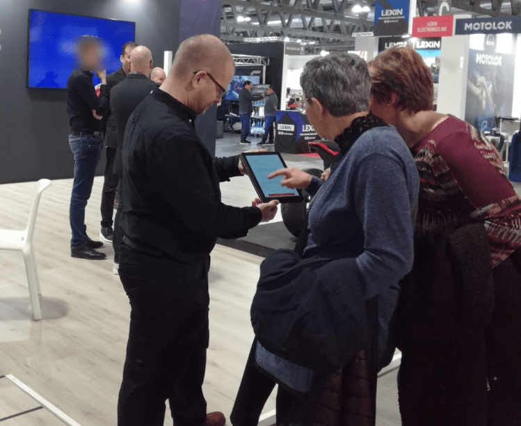 Two people entering info on a tablet.